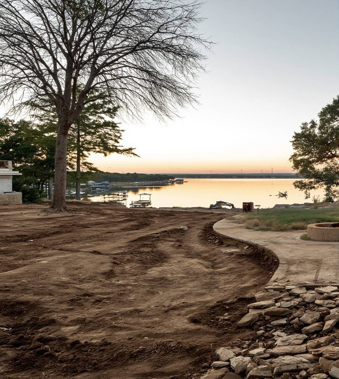 Before: graded dirt lakeside lot at sunset
